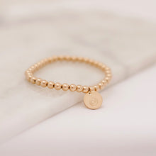 Gold beaded bracelet for breastfeeding moms